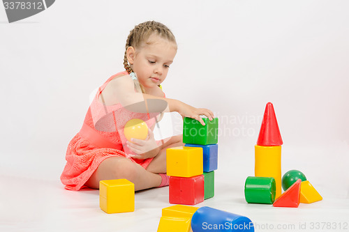 Image of Girl playing in developing a set of dice
