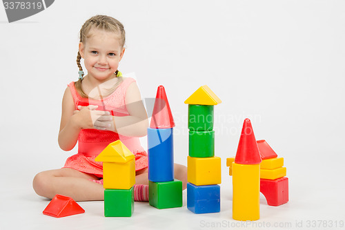 Image of Girl holding two dice and smiles