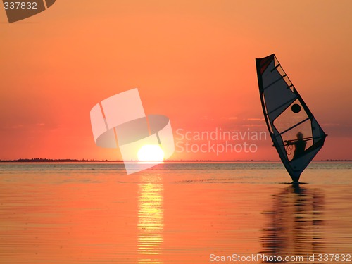 Image of Silhouette of a windsurfer on waves of a gulf on a sunset 3