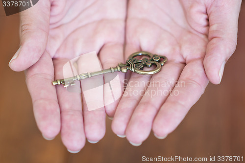 Image of hands with key