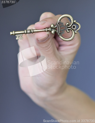 Image of key in a hand