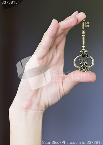 Image of key in a hand