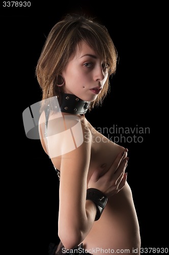 Image of Sexy woman with leather handcuffs and collar