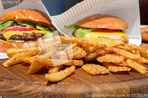 Image of fresh burgers and fries on tray