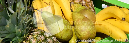 Image of pears pineapples bananas in a wooden box