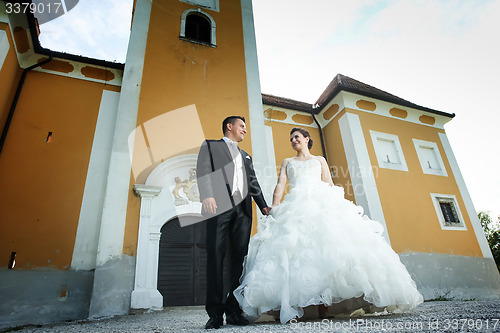 Image of Newlyweds posing in front of castle