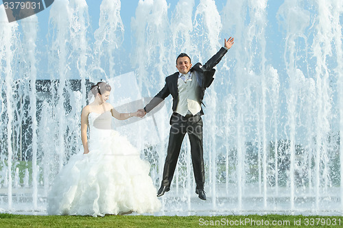 Image of Newlyweds in front of water fountain
