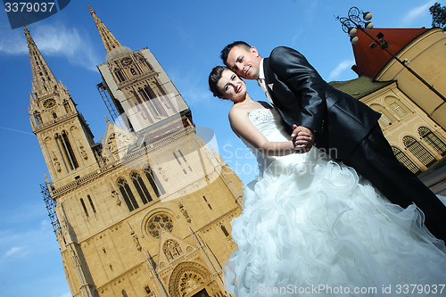 Image of Bride and groom posing in front of Cathedral