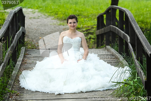 Image of Bride on wooden bridge