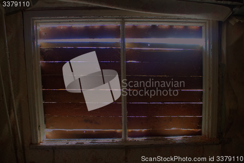 Image of boarded up window in the house