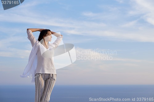 Image of young woman enjoy sunset