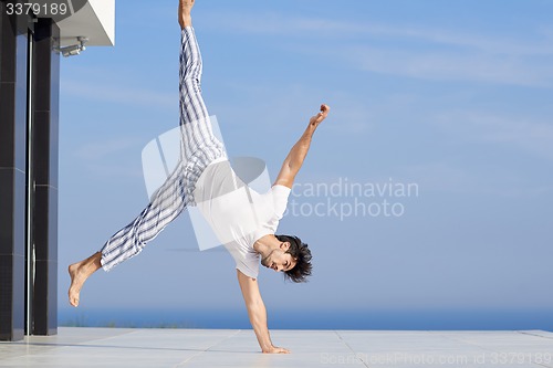 Image of young man practicing yoga