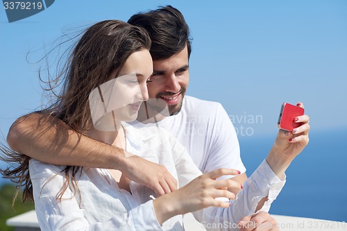 Image of young couple taking selfie with phone