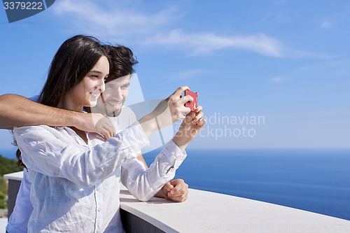 Image of young couple taking selfie with phone