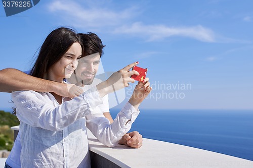 Image of young couple taking selfie with phone