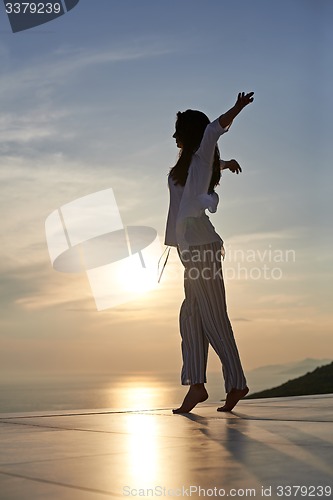 Image of young woman enjoy sunset