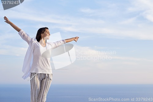 Image of young woman enjoy sunset