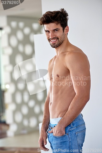Image of shirtles handsome young man in jeans