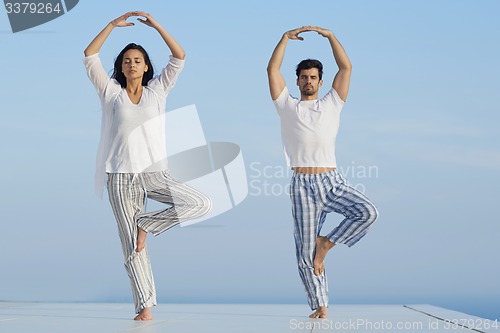 Image of young couple practicing yoga