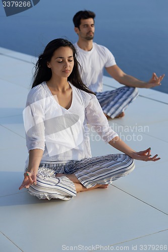Image of young couple practicing yoga
