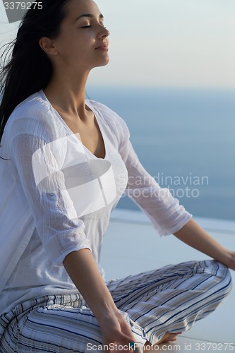Image of young couple practicing yoga