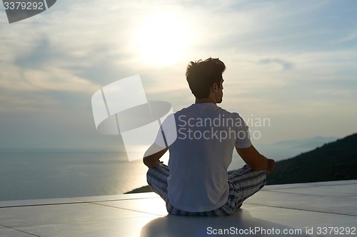 Image of young man practicing yoga