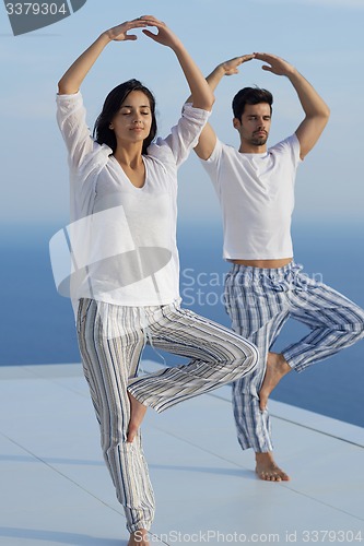 Image of young couple practicing yoga