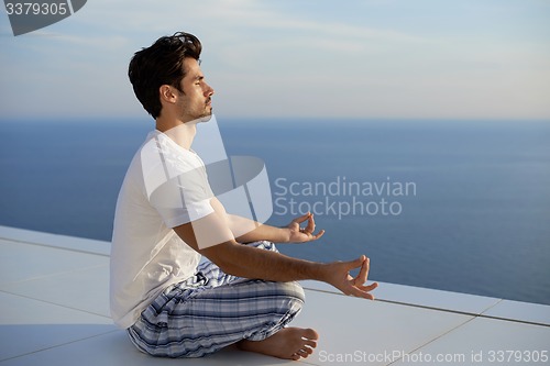 Image of young man practicing yoga