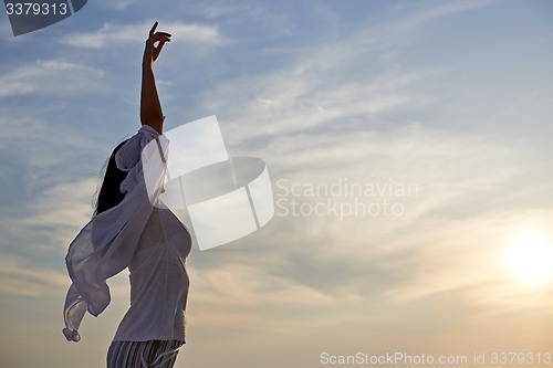 Image of young woman enjoy sunset