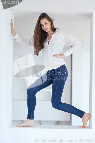 Image of young woman using cellphone at home