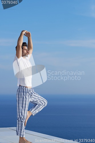 Image of young man practicing yoga