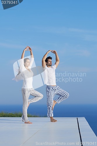 Image of young couple practicing yoga