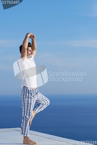 Image of young man practicing yoga