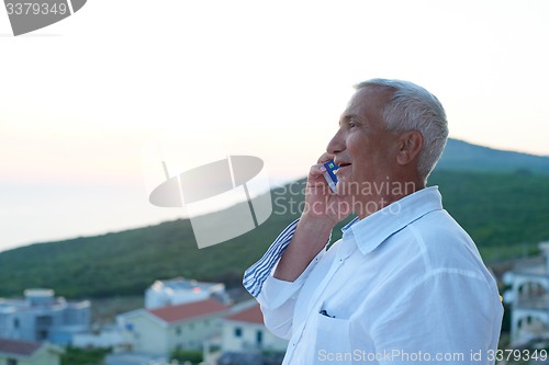 Image of senior man using smart phone