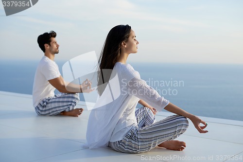 Image of young couple practicing yoga