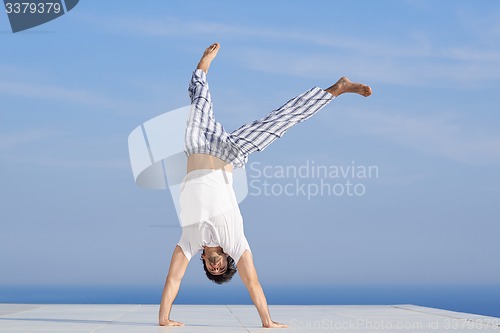 Image of young man practicing yoga