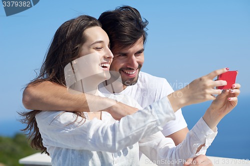 Image of young couple taking selfie with phone
