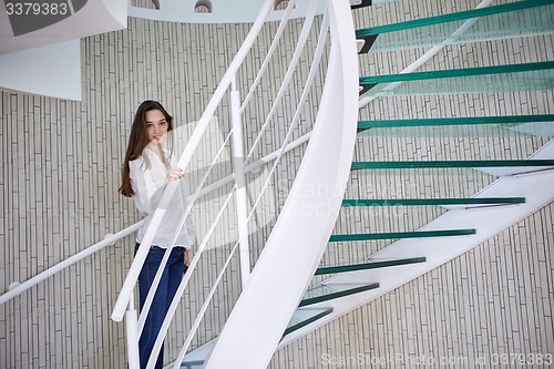 Image of woman walking on spiral stairs