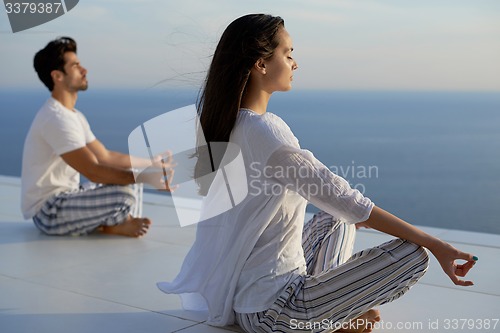 Image of young couple practicing yoga