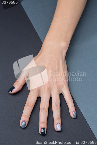 Image of Female hand with a stylish neutral manicure