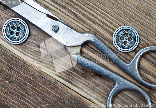 Image of vintage buttons and a dressmaker scissors