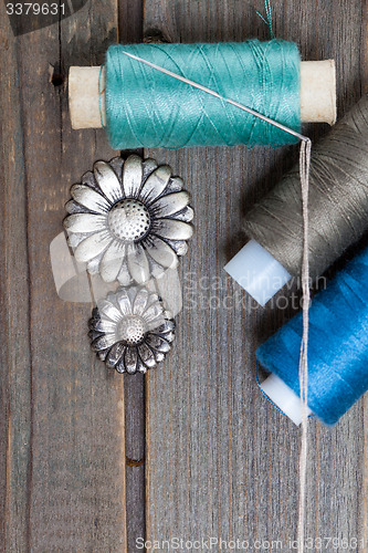 Image of vintage buttons flowers and spools with threads