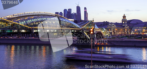 Image of Night cityscape Moscow city with bridge, river and motion boat