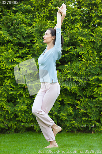 Image of beautiful adult woman doing yoga