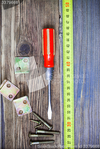 Image of Vintage screwdriver, screws, angles and measuring tape