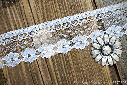 Image of vintage button and lace tape