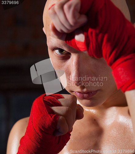Image of kickboxer with hands in red bandages