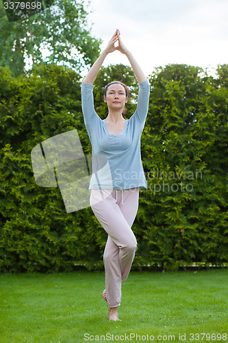 Image of beautiful adult woman doing yoga