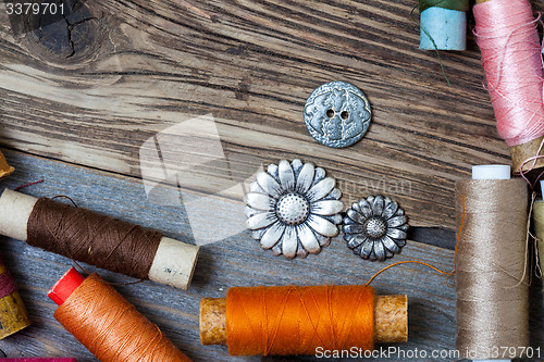 Image of vintage reels of varicolored thread and old buttons