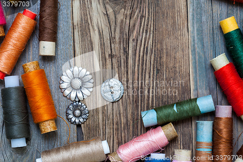 Image of vintage tools of thread and old buttons